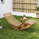 Acacia wood patio rocking sun lounger with ergonomic curved seat, perfect for poolside or backyard relaxation.
