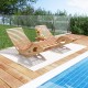Acacia wood patio rocking sun lounger with ergonomic curved seat, perfect for poolside relaxation and stability.