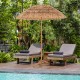 Thatched tiki umbrella with foldable stand, made of polyester and PP, providing sun protection for outdoor relaxation.
