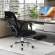 Ergonomic black mesh office chair with footrest, adjustable backrest, and wheels for comfortable workspace seating.