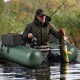 Inflatable fishing float tube in green with adjustable backrest, fish ruler, and storage pockets for angling.
