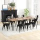 Stackable black metal dining chairs with cushioned seats and removable backs, ideal for dining rooms and cafes.