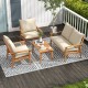 4-piece outdoor acacia wood conversation set with soft cushions, featuring a loveseat, two armchairs, and a coffee.