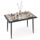 Rectangular sintered stone dining table with golden metal frame, elegantly set for four in a modern indoor dining room.