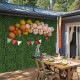 Artificial topiary gardenia shrub grass panels displayed on a wall, perfect for indoor or outdoor party decorations.