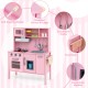 Wooden pretend play kitchen set in pink with microwave, oven, and removable sink for toddlers' imaginative play.