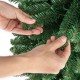 Hands adjusting the branch tips of a 5FT Pencil Christmas Tree with memory wire and warm LED lights for festive.