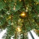 Close-up of the Pencil Christmas Tree's lush green branch tips with warm LED lights, perfect for festive decorations.