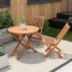 Outdoor bistro set featuring a round teak wood table and slatted chairs, perfect for backyard or poolside use.