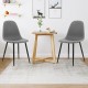 Close-up of gray dining chair with foam upholstery and black metal legs, showcasing the ergonomic backrest for enhanced.