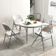 Round table set with four white folding chairs, featuring a metal frame and ergonomic design, ideal for versatile.