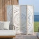 Boho 4-panel room divider with carved pattern, made of lightweight paulownia wood, ideal for privacy in any room.