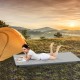 Foldable camping mattress in gray shown outdoors on grass, perfect for comfortable sleep while camping or picnicking.