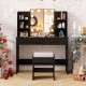 Black vanity set with lighted mirror, cushioned stool, and storage shelves, perfect for makeup and beauty routines.