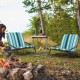 Low folding beach chairs with blue striped cushions, perfect for outdoor relaxation by the campfire.
