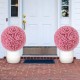 Two 17.5-inch faux pink eucalyptus decorative balls in white planters, perfect for garden or porch decoration.
