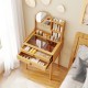 Small bamboo vanity desk with mirror, 2 drawers, and glass tabletop for organized storage in compact spaces.