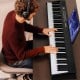 Foldable 88 key electric keyboard piano in black, featuring dual speakers and wireless MIDI for versatile music.