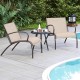 Two Rusic Brown wide armchairs with a side table, perfect for outdoor relaxation by the poolside.