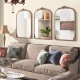 Three arched vintage gold metal frame mirrors with ornate baroque design, perfect for enhancing any living room decor.