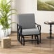 Patio glider rocking chair in gray with thick cushion and curved armrests, perfect for outdoor relaxation.