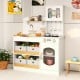 Kids kitchen playset in white with realistic stove, sink, and ample storage for organizing cooking accessories.