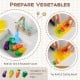 Toy vegetables including eggplant, corn, and carrot in a sink with a rotatable faucet for kids' kitchen playset.