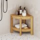 Teak wood shower bench with a corner design, featuring a 2-tier storage shelf for bathroom essentials.