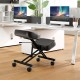 Height adjustable kneeling chair with black faux leather, padded cushions, and wheels for posture correction in an.