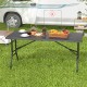 5FT folding picnic table with wood grain HDPE tabletop, set outdoors with food and drinks for versatile gatherings.