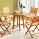 Round 31.5-inch patio dining table with slatted teak wood top and X-shaped frame, ideal for gardens and patios.