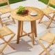 Round 31.5-inch patio dining table with slatted teak wood top and X-shaped frame, perfect for outdoor dining.