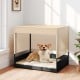 Elevated wicker dog house in black with removable cushion, suitable for small to medium breeds, for indoor or outdoor.
