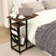 C-shaped end table with rustic wood grain, retractable tabletop, and built-in charging station for bedside convenience.