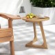 Teak wood side table showcasing a slatted design and triangle base, perfect for enjoying drinks outdoors or indoors.
