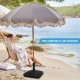 Fillable umbrella base in black with shell texture, designed for 6-10 ft patio umbrellas, shown on a beach setting.