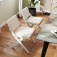 Two white wooden dining chairs with padded cushions, featuring rubber wood frames, ideal for modern farmhouse.