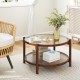 Round coffee table showcasing a tempered glass top and rustic hand-woven rattan shelf, enhancing cozy living room.