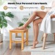 Non-slip shower bench with curved top and storage shelf, made of solid teak, ideal for personal care and accessibility.