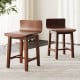 Set of 2 walnut swivel dining chairs with low backs and curved seats, perfect for dining rooms and cafes.