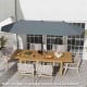 Double-sided 13 ft gray patio umbrella with crank handle, ideal for providing shade on patios and outdoor gatherings.