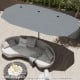 Double-sided 13 ft gray patio umbrella with crank handle, providing ample shade for outdoor lounging on the patio.