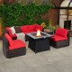 7-piece patio furniture set featuring a propane gas fire pit table, red cushions, and PE wicker for outdoor relaxation.