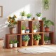 Solid wood 3 cube bookcase with open slatted design, showcasing plants and flowers, ideal for indoor or outdoor use.