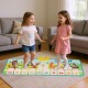 Kids playing on a colorful musical mat featuring animal sounds and piano keys, perfect for indoor and outdoor fun.