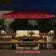 Double-sided 15.5 ft red patio umbrella featuring a solar panel and air vent, providing large shade coverage for.