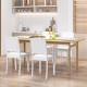White armless dining chairs with rubber wood legs, featuring a curved backrest for comfort and a rustic farmhouse style.