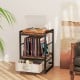 Industrial bedside table with open storage shelf, rustic brown wood, and removable fabric drawer for versatile use.