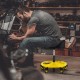 Height adjustable yellow rolling garage stool with tool tray storage, featuring a padded seat and 5 wheels for easy.