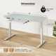 Height adjustable electric standing desk with white tempered glass top and storage drawer for ergonomic workspace.